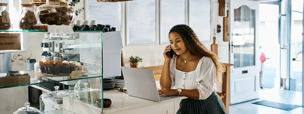 Entrepreneur talking on a phone in a trendy bakery shop. Jenks, Oklahoma Business Insurance.