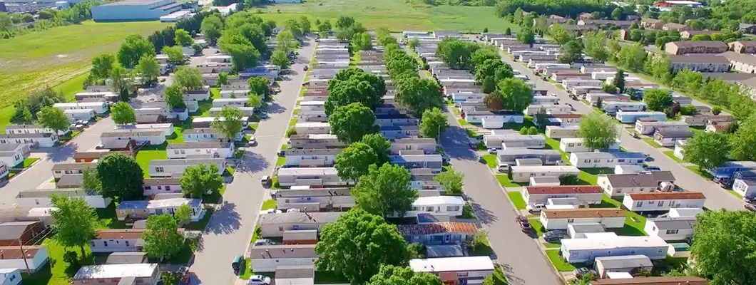 Mobile home park on sunny summer morning. Find Alabama Mobile Home Insurance.