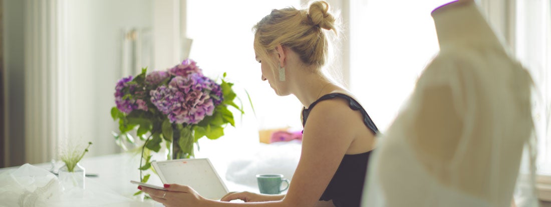 Wedding planner is working on computer. Find Wedding Planner Insurance.