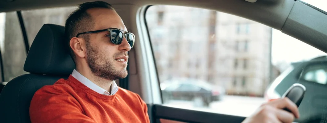 Young man driving a car. How to Find the Best Car Insurance in Saco, Maine.