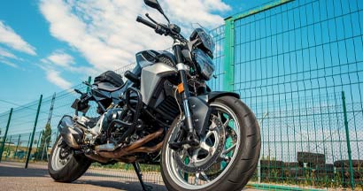 Racing motorcycle parked near the fence. Average Cost of Motorcycle Insurance.