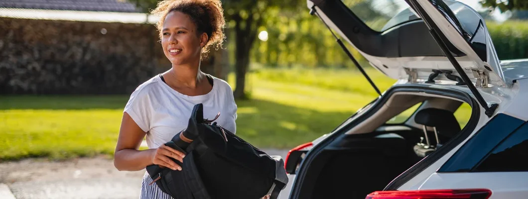 Woman packing bags for roadtrip. Find Independence, Kentucky car insurance.