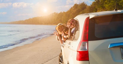 Family having fun together on the beach in summer holiday vacation. Why Is Car Insurance So Expensive in Florida?