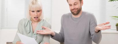 couple looking at car insurance bill