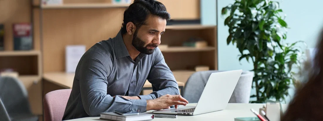 Man working on laptop at home office. Compare Landlord Insurance.