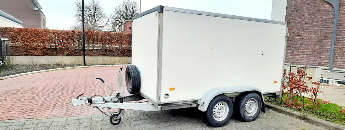 Trailer on an empty parking place. Choosing the Best Snowmobile Trailer.