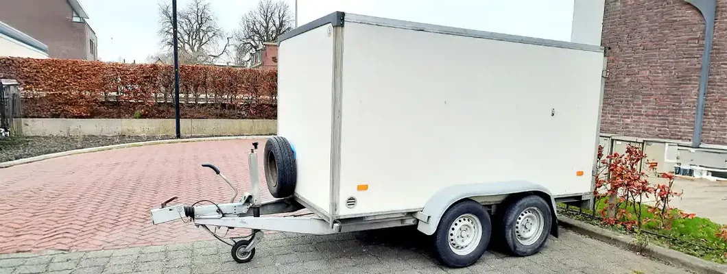 Trailer on an empty parking place. Choosing the Best Snowmobile Trailer.