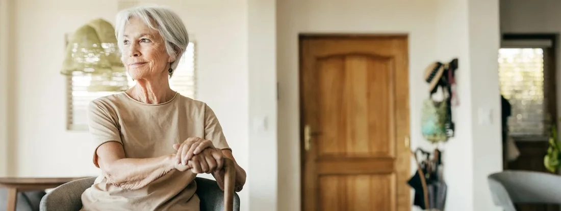 Woman sitting in chair looking out window. Facts on Life Insurance without a Medical Exam.