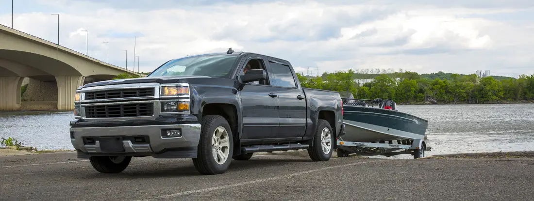 Truck with Boat in summer. How to File Trailer Insurance Claims.