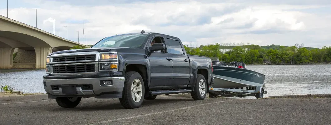 Truck with Boat in summer. How to File Trailer Insurance Claims.