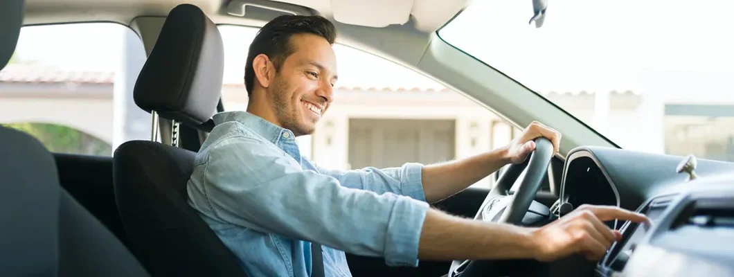 Male driver using the GPS navigation map on the car. Glendale, Arizona Car Insurance.