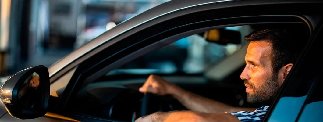 Man driving. Find Leawood, Kansas car insurance.