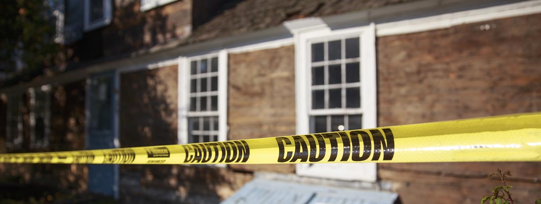 Caution tape blocking the way into the building. Does my Homeowners Insurance Cover Death Cleanup?