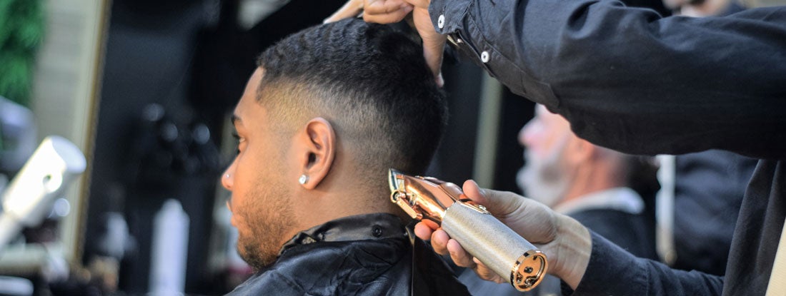 Man getting haircut at barber shop. South Carolina Barber Shop Insurance.