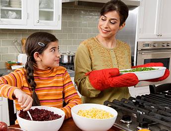 Mother and daughter cooking together 