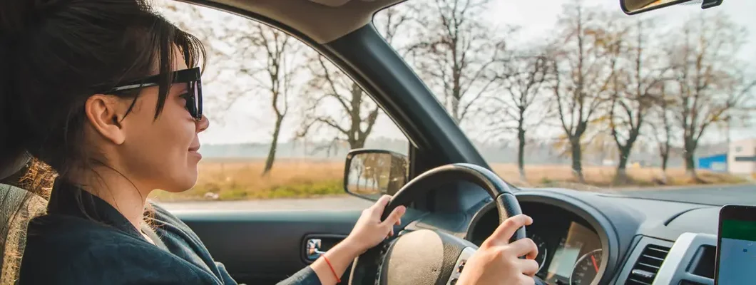 Woman driving during fall. Find Haddonfield, New Jersey car insurance.