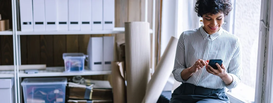 Businesswoman Texting While Sitting In The Office. How to Find the Best Business Insurance Coverage in Mercer Island, Washington.