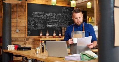 Restaurant owner reviewing insurance options. Find Business Insurance for Restaurants.