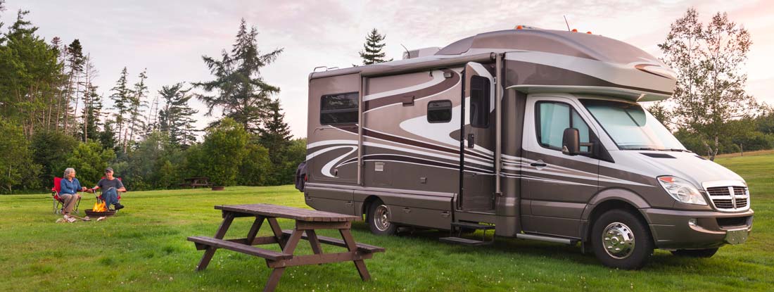 Couple camping with their RV. Find RV Insurance.