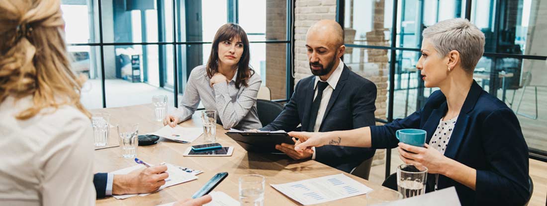 Business team having meeting in an office. Joint Employer Workers Compensation.