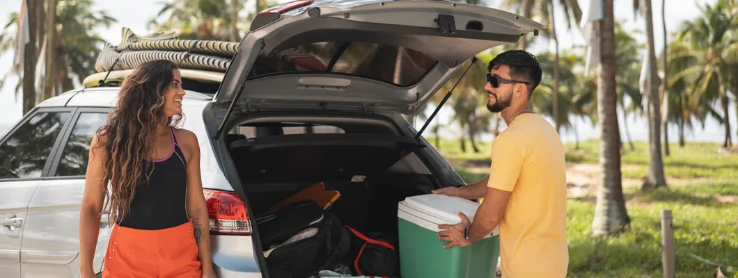 Man organizing truck of car for travel. Find the Best Car Insurance in Ewa Gentry, Hawaii at an Affordable Rate.