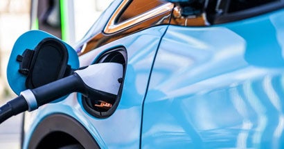 Electric cars seen during the charging. The Pros and Cons of Buying an Electric Car. 