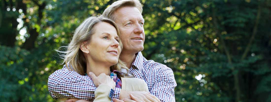 Mature couple embracing outdoors. Fixed Income Annuity with Inflation.
