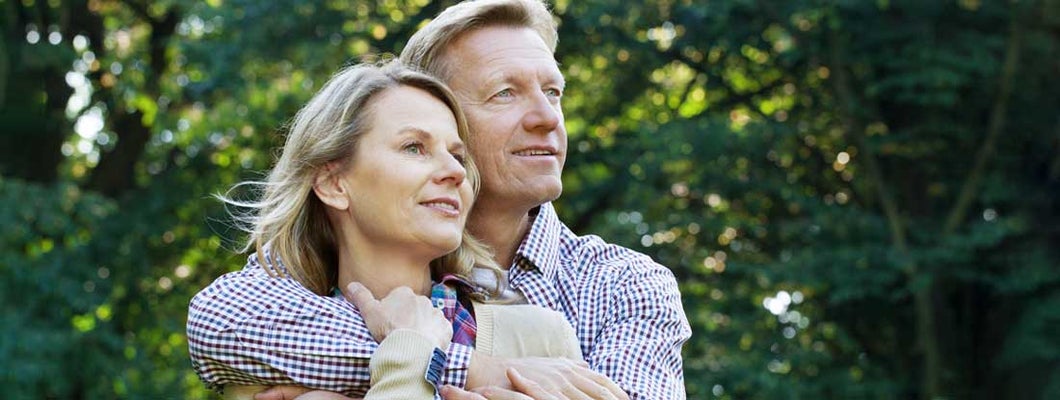 Mature couple embracing outdoors. Fixed Income Annuity with Inflation.