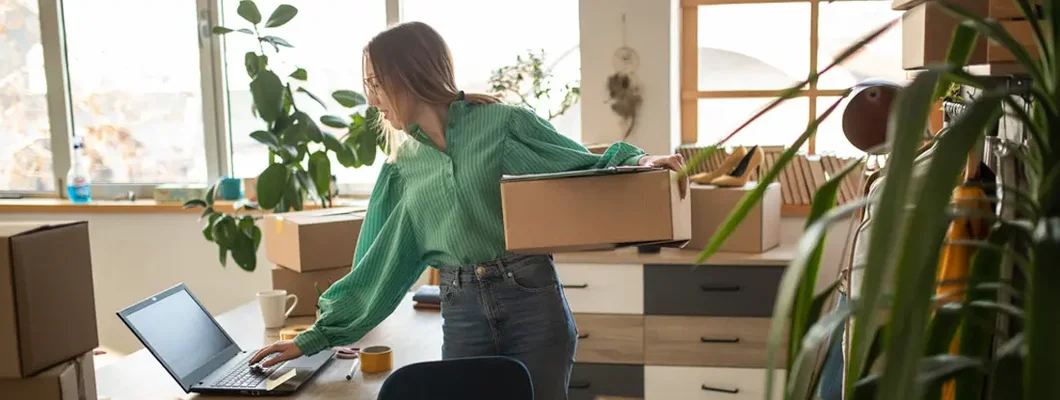 Woman accepting new orders in her online fashion shop. Find Whitefish Bay, Wisconsin business insurance.