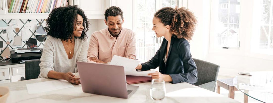 Couple speaking to their accountant.