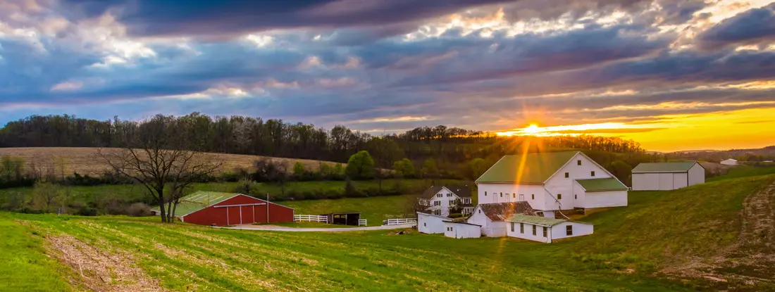 Sunset over a farm in rural York County, Pennsylvania. Find Agribusiness Umbrella Insurance.