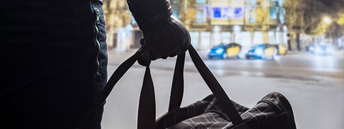 Terrorist figure at public transport hub. Find Terrorism Insurance.