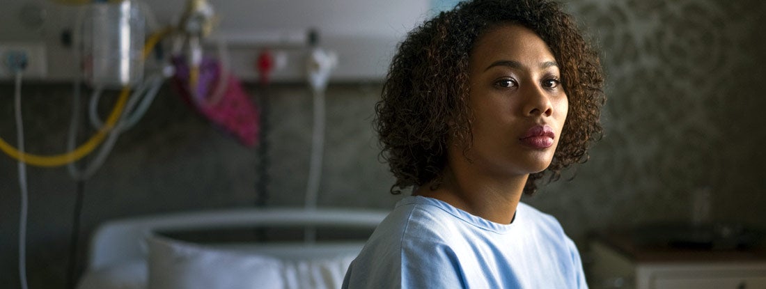 Thoughtful female patient sitting at hospital. How long does group short term disability last.