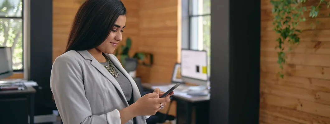 Landlord standing in the office and calling a tenant. Find North Dakota landlord insurance.