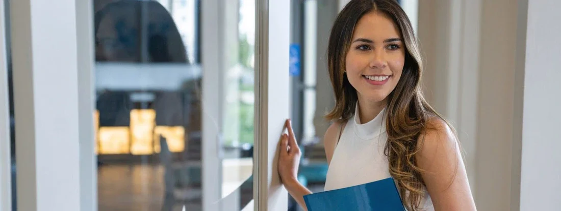 Happy Real Estate Agent showing a house. Find Vermont Landlord Insurance.