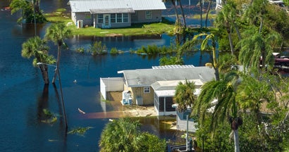 Surrounded by hurricane Ian rainfall flood waters homes in Florida residential area. What is a flood zone?