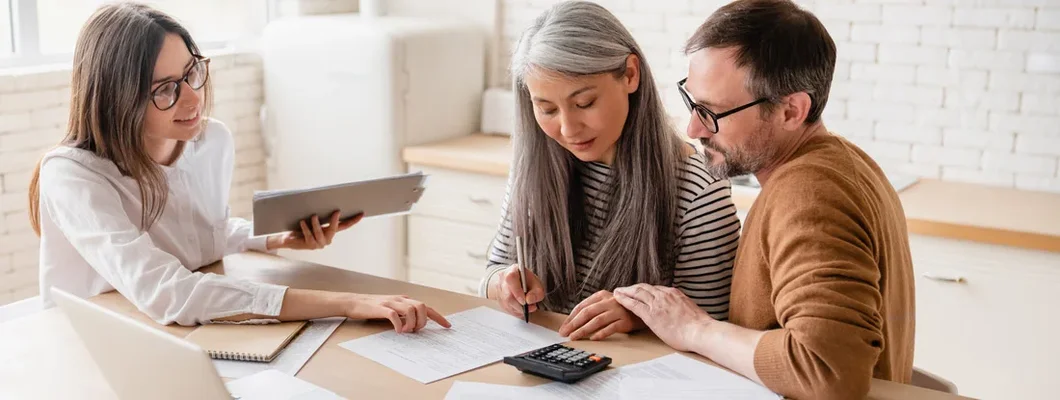 Insurance agent consulting mature family couple. Find Nevada Landlord Insurance.