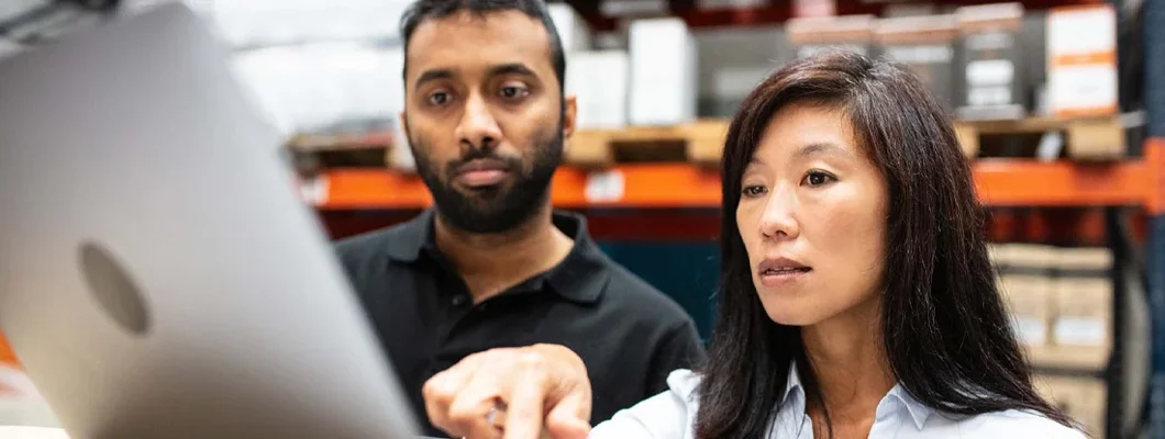 Warehouse staff working on a laptop. How to Find the Best Business Insurance in Narragansett, Rhode Island