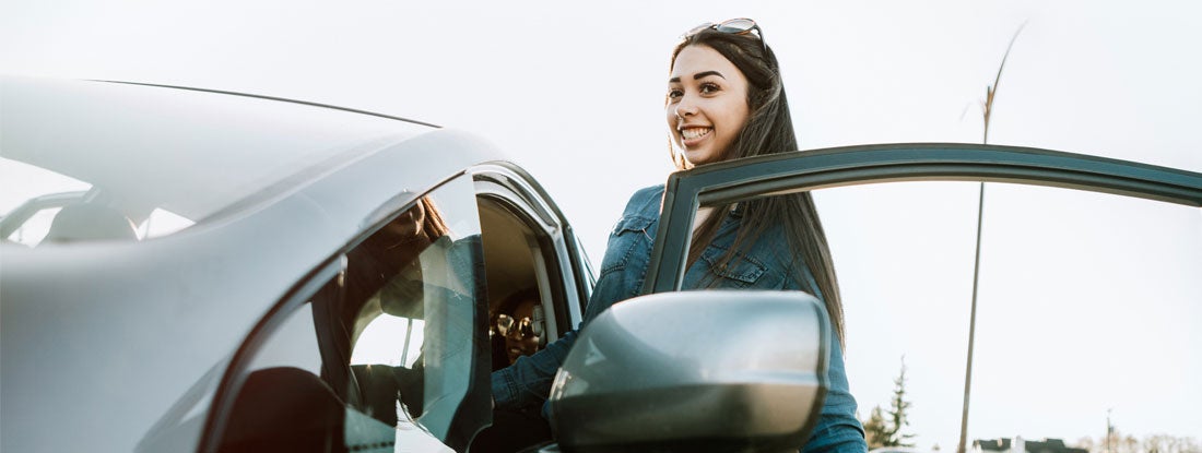 Group of Young Adults Having Fun Riding in Car. Find Good Student Discounts.