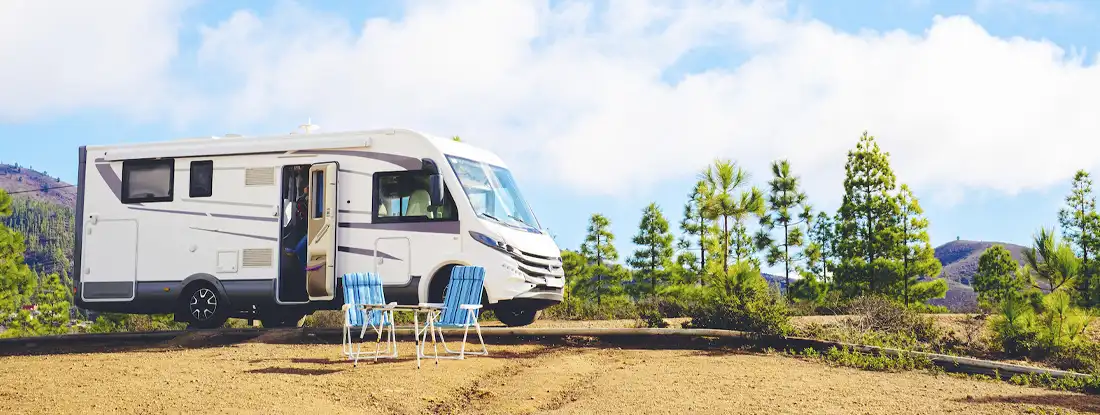 RV in nature at campsite. Top Things to Have In Your RV at Affordable Prices.