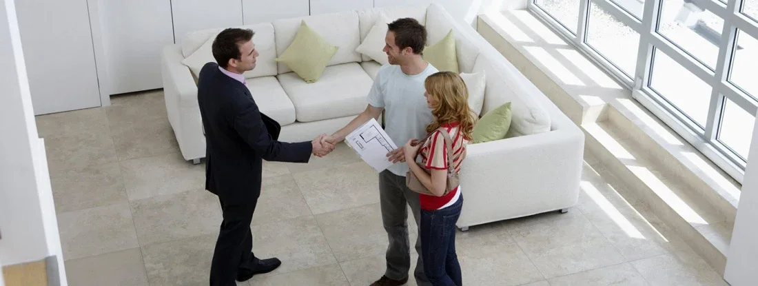 Landlord with Couple Renting New Apartment. Find Utah Landlord Insurance.