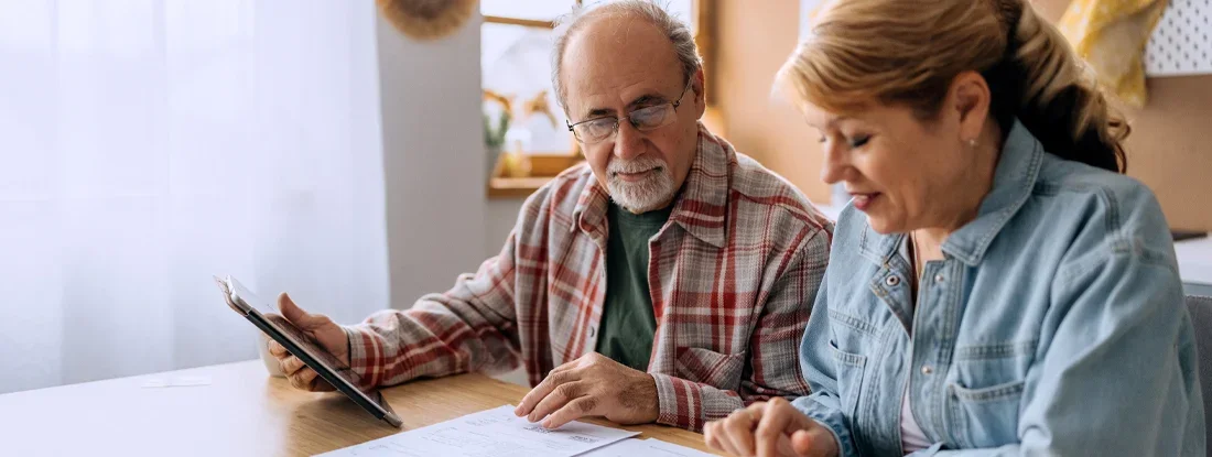 Couple managing expenses and bills at home. Find Health Insurance Cost.