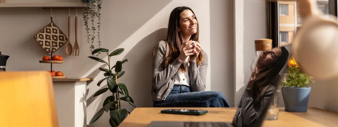 Woman sipping steaming coffee while standing near sunlit kitchen counter. Does Renters Insurance Cover Theft Outside the Home in 2026?