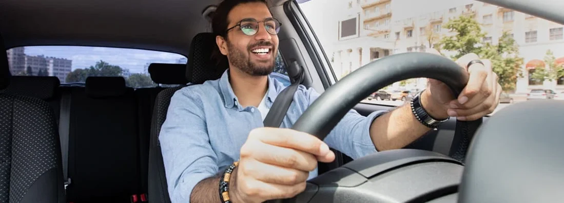 Man driving car. Does Car Insurance Cover the Car or the Driver?