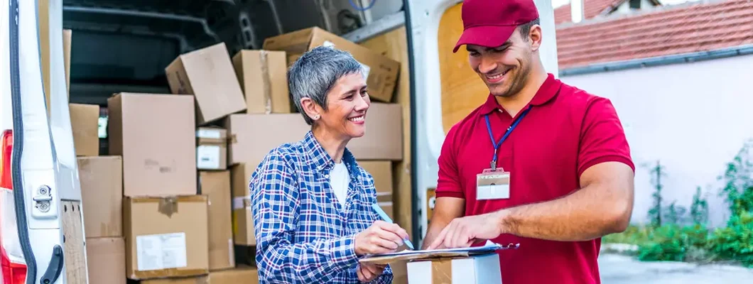 Woman signing for her delivery from the courier. Find Alabama Commercial Vehicle Insurance.