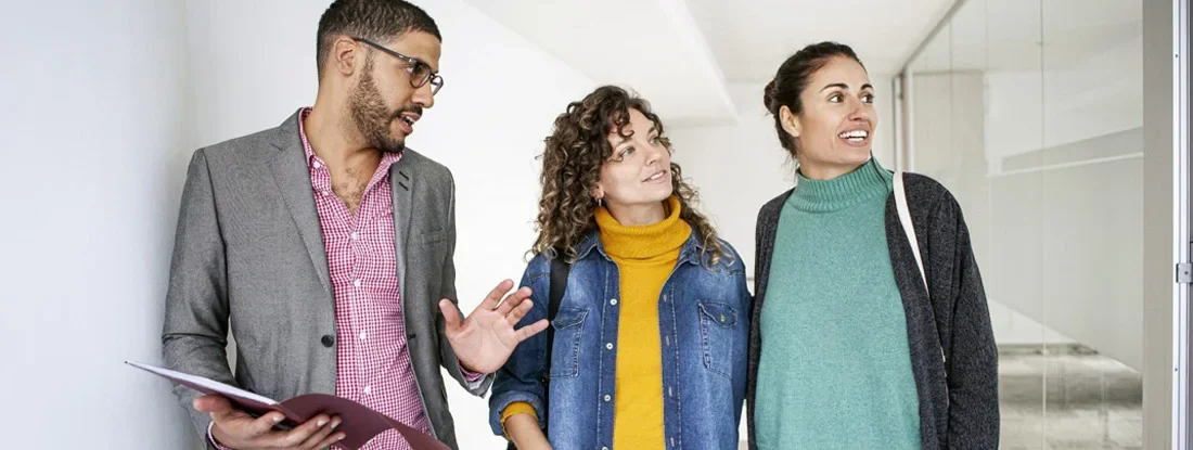 Real Estate Agent showing office to a couple. Find Tennessee Landlord Insurance.