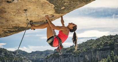 Female rock climber. Factors that affect life insurance premiums.