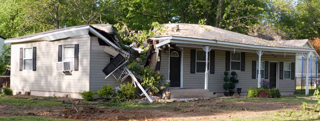 A damaged home after a large tree fell on it during a tornado. How long until you get paid on a Home Insurance Claim?