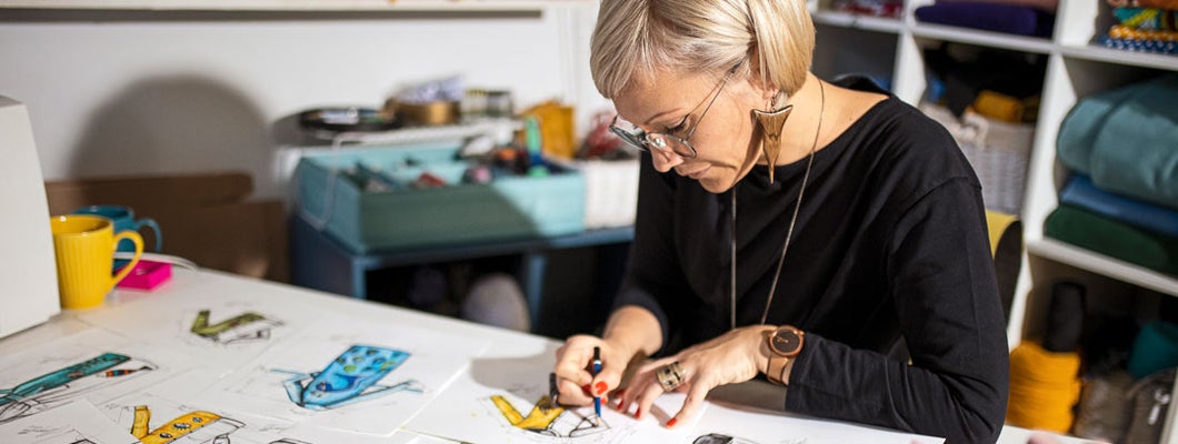 Designer drawing ideas on table. Find Raleigh North Carolina business insurance.