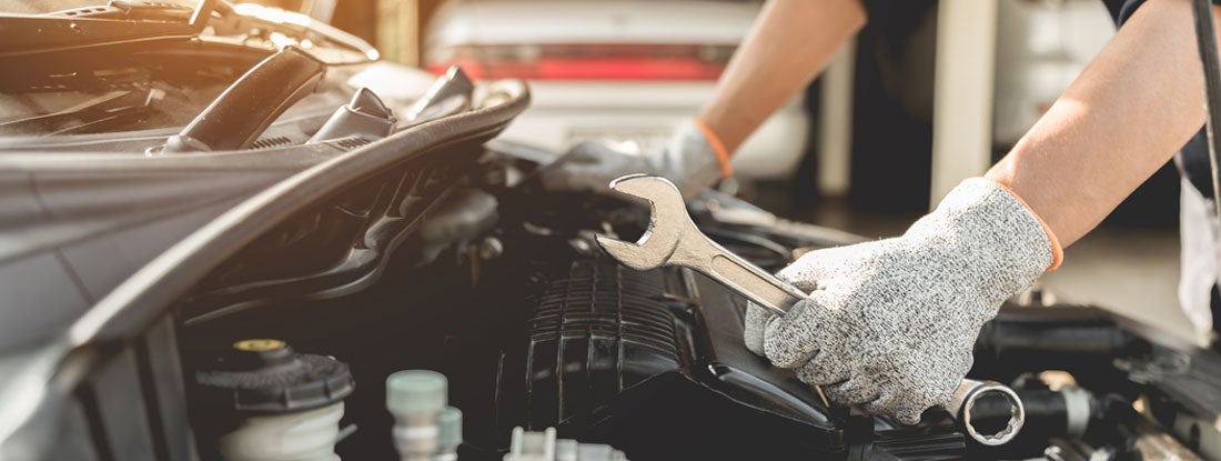 Mechanic working on car. Massachusetts Garage Keepers Insurance.